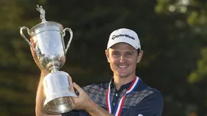 Justin Rose Smiling While Raising A Trophy Wallpaper