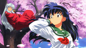 Kagome Higurashi Striking A Pose Amidst A Vibrant Background Wallpaper