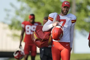 Kansas City Chiefs Player Carrying Helmetand Gear Wallpaper