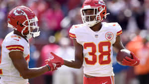 Kansas City Chiefs Players Celebrating On Field Wallpaper