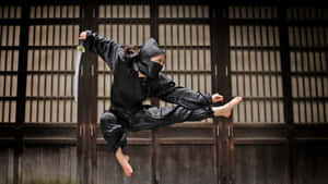 Karate Practitioners Wear Traditional Martial Arts Uniforms During A Training Session. Wallpaper