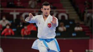 Karate Practitioners Wearing Traditional Martial Arts Uniforms Showcasing Their Power Wallpaper