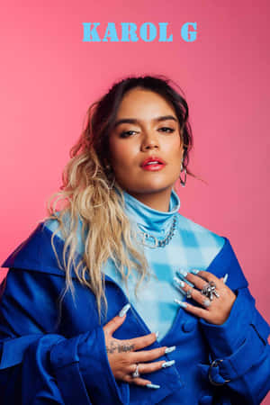 Karol G Blue Attire Pink Backdrop Wallpaper