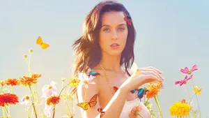 Katy Perry Enjoying A Stroll Through A Colorful Flower Field Wallpaper