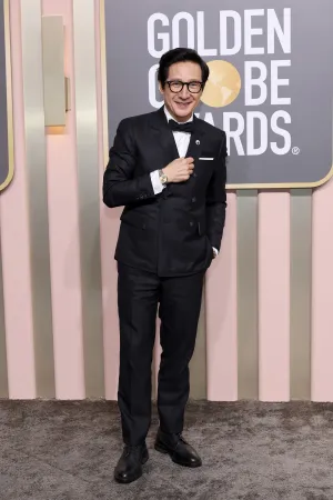 Ke Huy Quan Posing At An Event Wallpaper