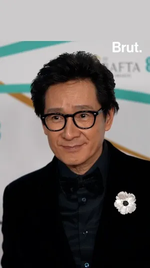 Ke Huy Quan Posing For A Portrait Wallpaper