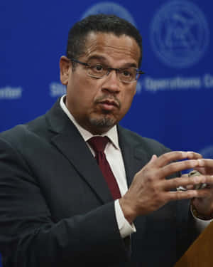 Keith Ellison Forming Hands Into Circle Wallpaper