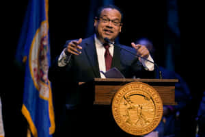 Keith Ellison Speaking At Minnesota Podium Wallpaper