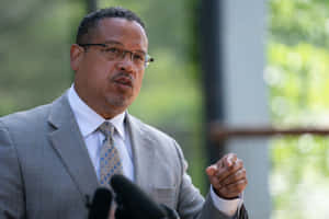 Keith Ellison Subtly Pointing Outwards Wallpaper