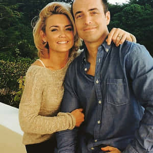 Kelly Carlson Striking A Pose In A Stylish Outfit Wallpaper