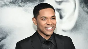 Kelvin Harrison Jr Smiling Black Suit Event Wallpaper