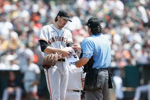Kevin Gausman Covering White Towel On His Left Arm Wallpaper