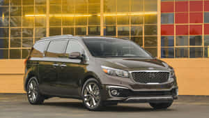 Kia Sedona Cruising On A Scenic Road Wallpaper