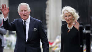 King Charles Iii Waving With Camilla Wallpaper