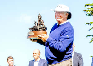 Kirk Triplett Holding A Trophy Wallpaper