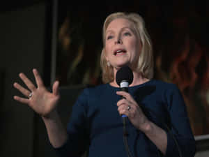 Kirsten Gillibrand Holding Microphone Wallpaper