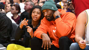 Kobe Bryant And His Daughter Gigi At A Basketball Game Wallpaper