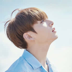 Kpop_ Artist_ Gazing_ Upward_ Profile Wallpaper