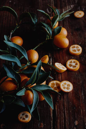 Kumquat Fruits With Leaves On Wood Wallpaper