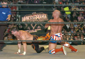 Kurt Angle Holding Eddie Guerrero In A Leg Lock Wallpaper