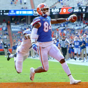 Kyle Pitts Catching Football Game Wallpaper