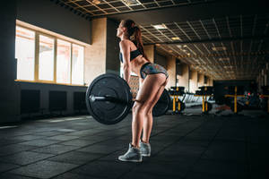 Lady Lifting A Barbell Wallpaper