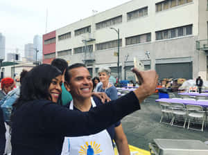 Lady Taking Selfie With Antonio Villaraigosa Wallpaper