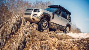Land Rover Defender Conquering Off-road Terrain Wallpaper