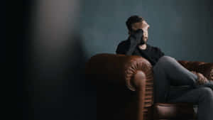 Languishing Man On The Couch Wallpaper