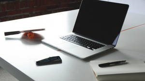 Laptop On Marble Office Desk Wallpaper