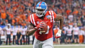 Laremy Tunsil Running With The Football Wallpaper