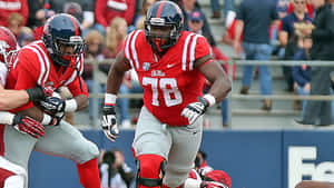 Laremy Tunsil Sprinting In Red Jersey Wallpaper