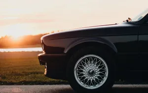 Lateral View Of A Black Car Wallpaper