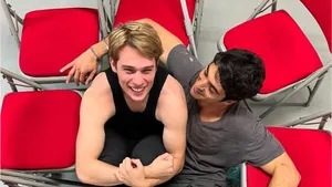 Laughing Duo Red Chairs Wallpaper