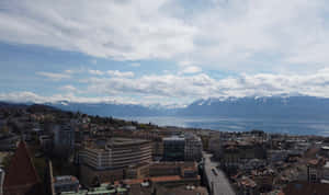 Lausanne Cityscapewith Lake Genevaand Alps Wallpaper