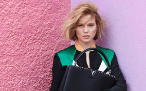 Lea Seydoux Dazzles Against A Pink Wall Backdrop. Wallpaper