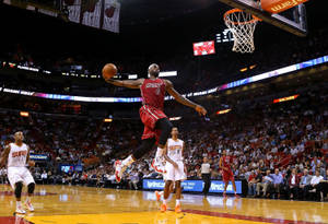 Lebron James Slams In A Dunk At The Nba Game Wallpaper