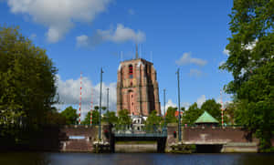 Leeuwarden Historic Church By Canal Wallpaper