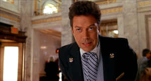 Legendary Actor Tim Curry Smiling In An Iconic Pose Wallpaper