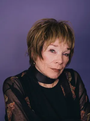 Legendary Actress Shirley Maclaine In Classic Black Dress Wallpaper