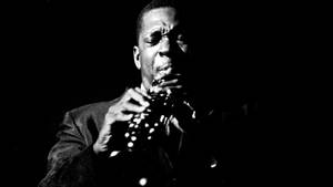 Legendary American Saxophonist John Coltrane Playing At The Village Gate In 1961 Wallpaper