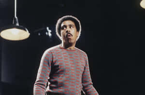 Legendary Comedian Richard Pryor Against Sky-blue Background Wallpaper