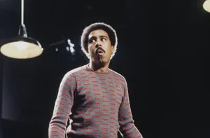 Legendary Comedian Richard Pryor Against Sky-blue Background Wallpaper
