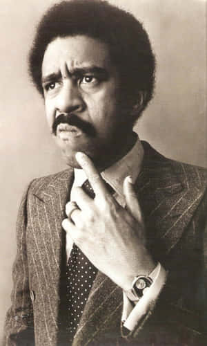 Legendary Comedian Richard Pryor Holding A Mic On Stage Wallpaper