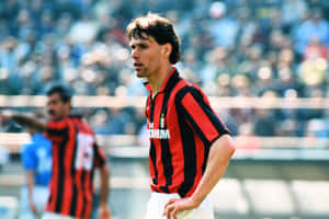 Legendary Footballer Marco Van Basten In A Striped Polo And Shorts Wallpaper