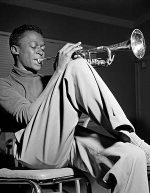 Legendary Jazz Bandleader Miles Davis Performing Wallpaper