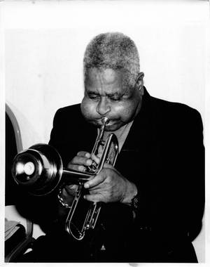 Legendary Jazz Musician Dizzy Gillespie Blowing His Trumpet Wallpaper