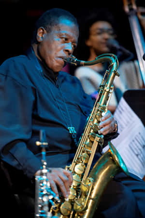 Legendary Jazz Musician Wayne Shorter Performing On Stage. Wallpaper