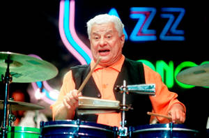 Legendary Latin Music Icon Tito Puente In Action Wallpaper