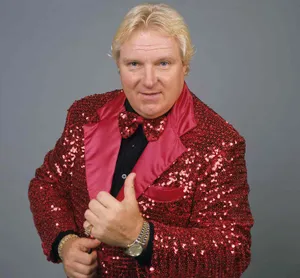Legendary Wrestler Bobby 'the Brain' Heenan In Striking Red Suit Wallpaper